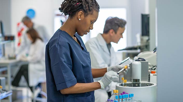 Female research technician holding vials 