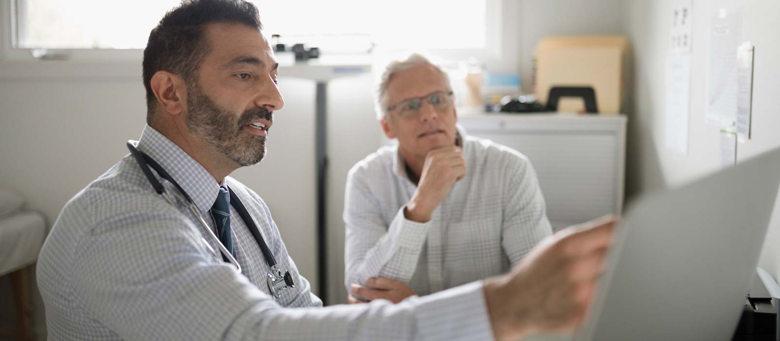 Doctor discussing with male patient