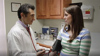 doctor checks patient''s blood pressure