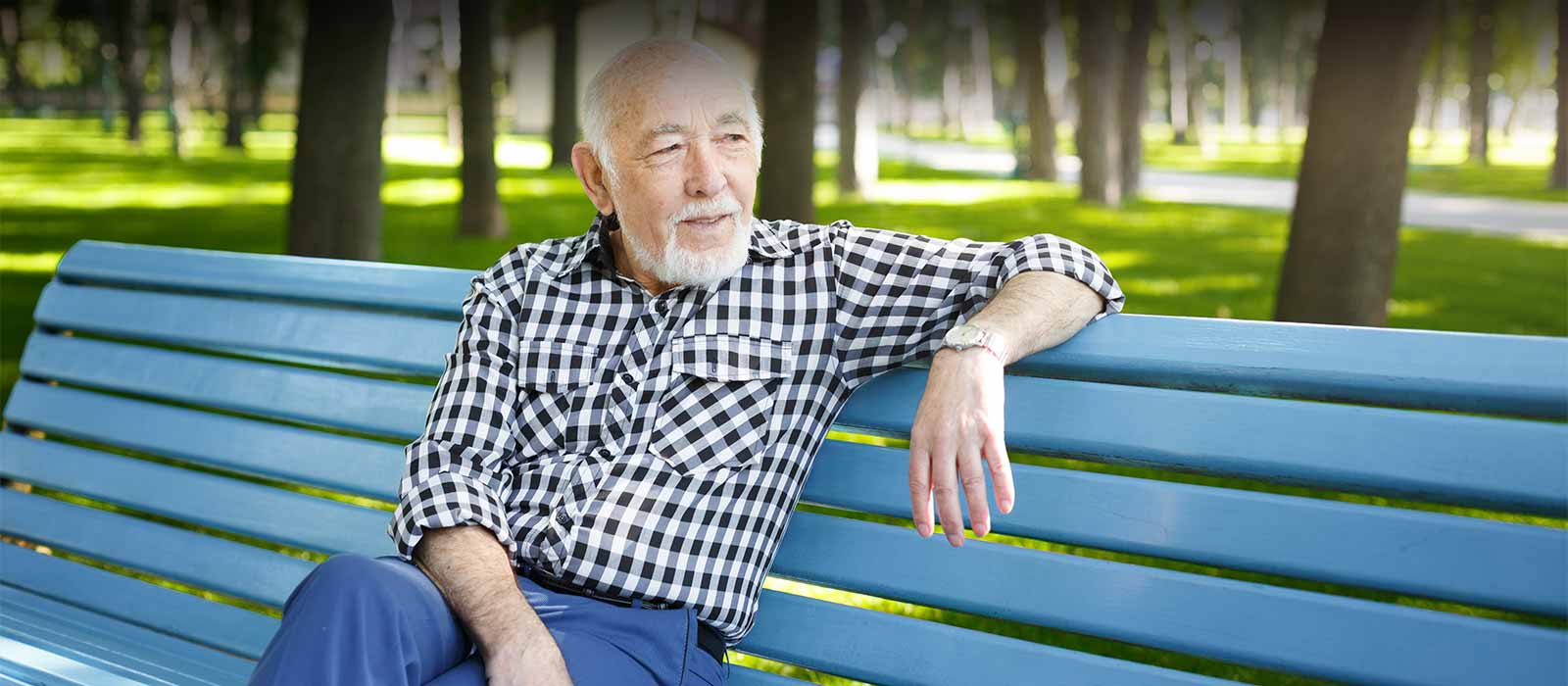 Mature man relaxing on park bench