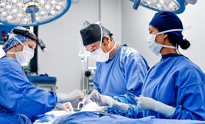 three surgeons in operating room