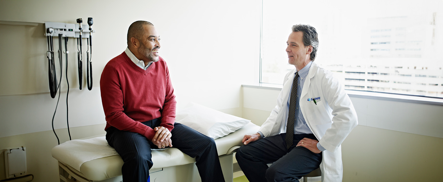 Diverse patient with doctor in exam room