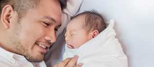 Diverse newborn and father