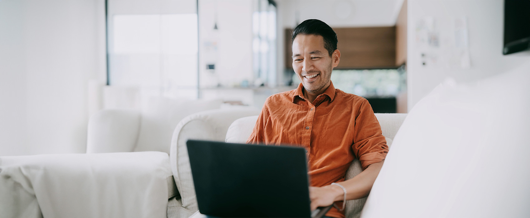 Man with laptop on couch