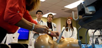 students watching a medical simulation exercise