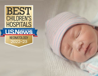 Infant sleeping with award badge 