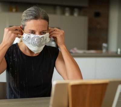 Mature woman putting on homemade mask