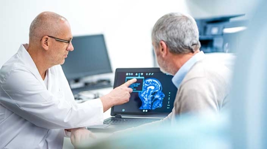 neurologist consulting patient on images