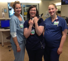 3 nurses holding a tiny dog